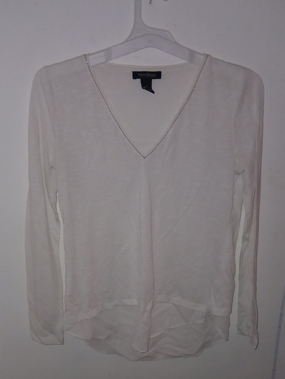 White House Black Market white longsleeve V-neck top featuring a lightweight,hem